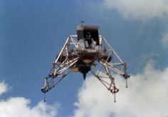 an upside down tower in the sky with clouds around it and a camera on top