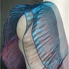 the back of a mannequin's dress with blue and purple sheers