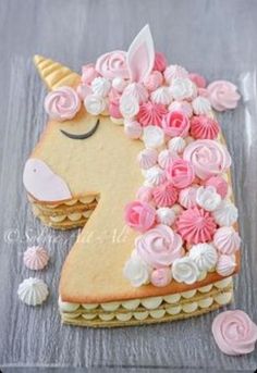 a cake shaped like a unicorn with pink and white frosting