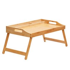 a small wooden tray with handles and legs on it, sitting on a white background