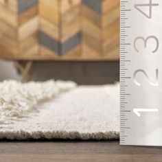 a white rug with a ruler next to it