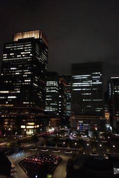 the city skyline is lit up at night