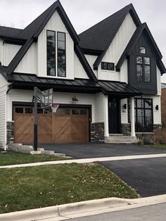 a large house with two garages and a basketball hoop