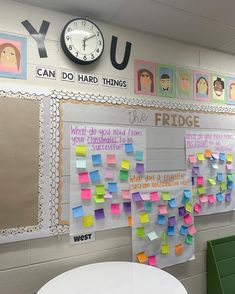 a bulletin board with post - it notes on it and a clock mounted to the wall