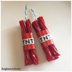 two red candles wrapped in plastic with the words tht on them