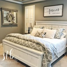 a white bed sitting in a bedroom on top of a hard wood floor