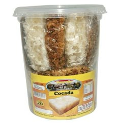 a plastic container filled with rice and meat covered in coconut flakes on top of a white background