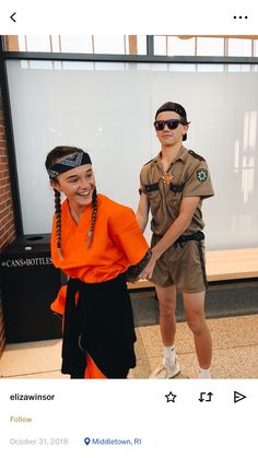 two people dressed in costumes standing next to each other and one person wearing an orange shirt