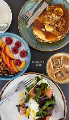 three plates with different foods on them sitting on a table next to cups and saucers