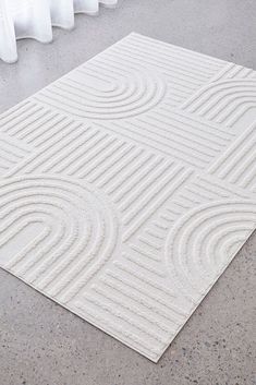 a white rug with wavy lines on it