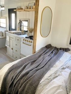 a bed in a bedroom next to a stove top oven