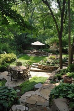 an outdoor patio with tables and chairs surrounded by greenery, shrubs and trees in the background