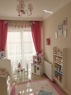 a child's bedroom decorated in pink and white