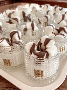 small glass cups filled with marshmallows on a tray