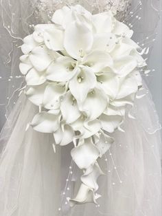 a bridal bouquet with white flowers on it