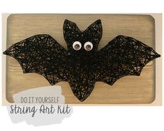 a string art bat with googly eyes on it's back and the text do you yourself string art kit