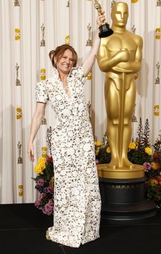 the actress poses with her oscar statue