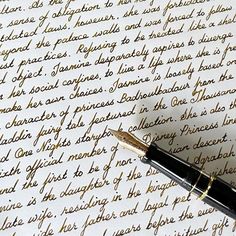 a fountain pen sitting on top of a piece of paper that has writing on it