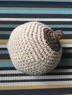 a small crocheted ball sitting on top of a rug