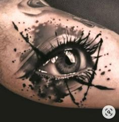 an eye with black ink and watercolors on the upper half of the arm