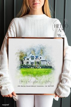 a woman holding up a painting with the words home is where it's belong