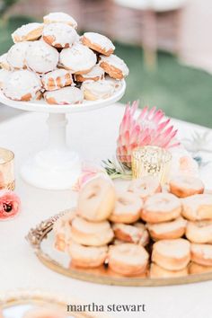 a table topped with lots of donuts and other desserts on top of it