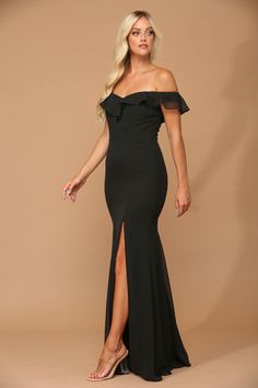 a woman wearing a black dress with an off the shoulder top and slited skirt