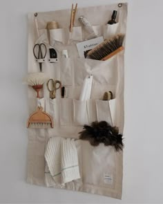 a white wall hanging with various items on it