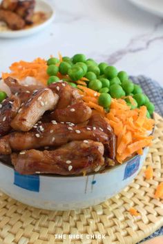 a bowl filled with meat and veggies on top of a table