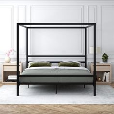 a bed that is sitting in the middle of a room with white walls and wood flooring