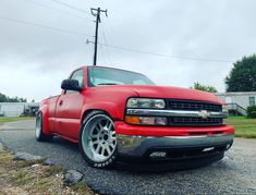 the red truck is parked on the side of the road