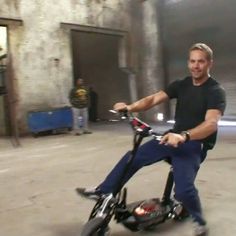 a man riding on the back of a scooter