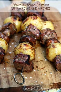 grilled steak, potato and mushroom kabobs on a wooden cutting board with text overlay