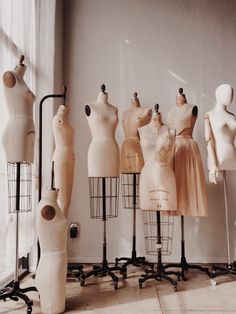 black and white photograph of mannequins on display in front of a window