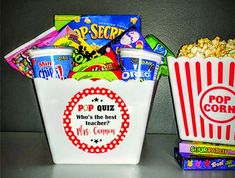 two buckets filled with candy and popcorn