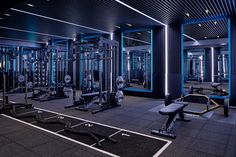 an empty gym with rows of exercise equipment