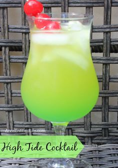 a green drink with a cherry on top