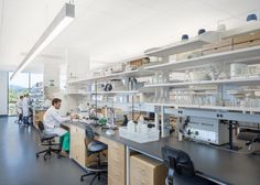 two people working in a lab with lots of shelves