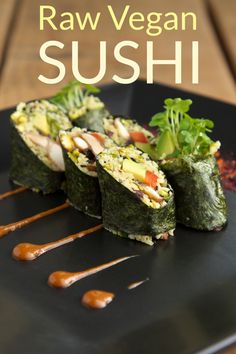 raw vegan sushi on a black plate with sauce