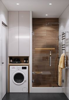 a white washer sitting next to a dryer in a bathroom