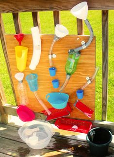 there are many different items on the back porch table, including cups and utensils