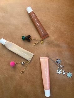 the contents of an assortment of personal care products on a brown surface, including lip balm, toothpaste and necklaces