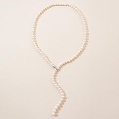 The Adjustable Pearl Lariat Necklace is approximately 27 inches in length with beautifully graduated freshwater pearl gemstones. The pearls are 7mm with the end steadily increasing to larger 10mm pearls. The sterling silver clasp allows you to adjust the graduated strand to a length unique to you. The strand can also be worn down the back to accent that backless dress or as a perfect bridal ensemble. Elegant Pearl Lariat Backdrop Necklace, Adjustable Pearl White Lariat Necklace, Adjustable Lariat Pearl White Necklace, Pearl Pendant Lariat Backdrop Necklace, Pearl Lariat Backdrop Necklace With Pearl Pendant, Formal Lariat Pearl Necklace With Pendant, Formal Pearl Pendant Lariat Necklace, Formal Lariat Pearl Pendant Necklace, Elegant Long Drop Single Strand Lariat Necklace