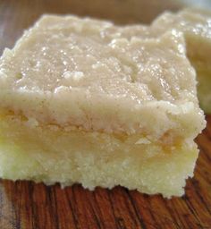 two pieces of cake sitting on top of a wooden table