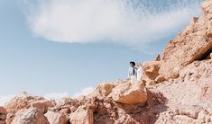 a man standing on top of a rocky mountain