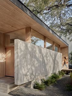 an image of a house that is made out of wood and concrete with the door open