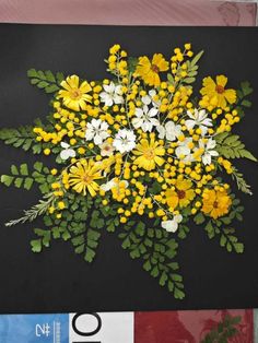 a bunch of yellow and white flowers on a black background