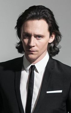 a man in a black suit and white shirt