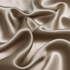 a close up view of a satin fabric with very soft folds and smooth lines on it