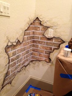 a brick wall that has been torn down and is in the process of being painted